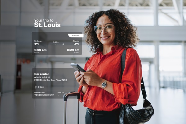 Woman at airport with travel itinerary display.