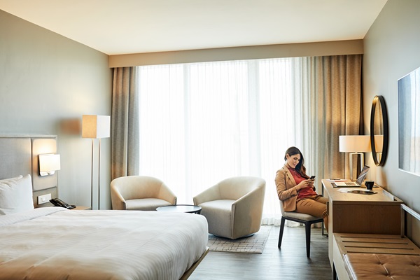 Woman relaxing in modern hotel room.