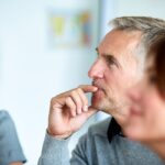 Man attentively listening in a meeting session.