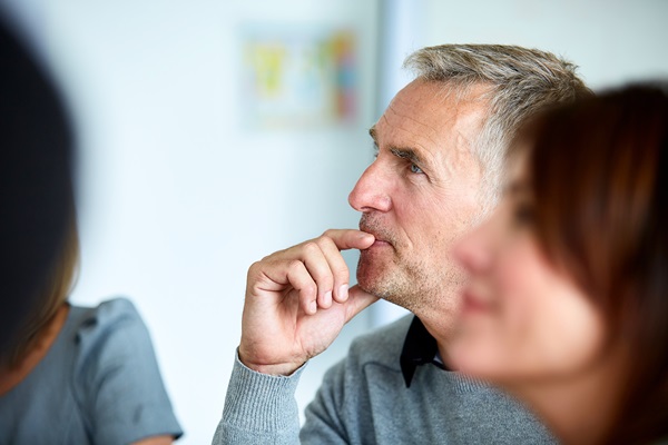 Man attentively listening in a meeting session.