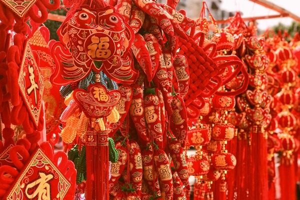 Red Chinese New Year decorations and ornaments displayed.