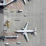 Aerial view of airplane at airport gate.