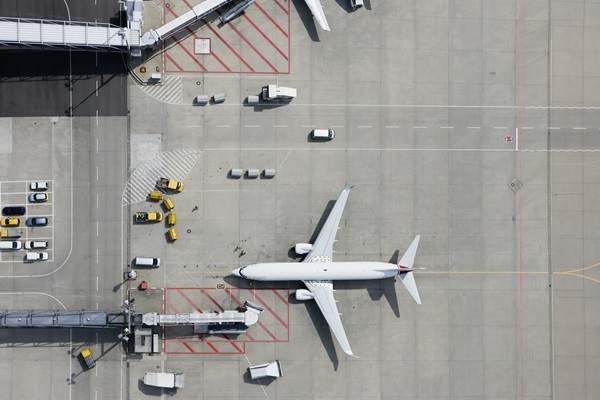 Aerial view of airplane at airport gate.